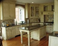 Custom kitchen cabinets by AppWood featuring 1 inch thick inset doors and antique glaze finish