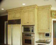 Custom kitchen cabinets by AppWood featuring 1 inch thick inset doors and antique glaze finish