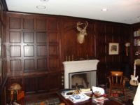 Custom cherry wall panels with hidden door by AppWood