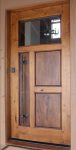 This rustic yet contemporary entry built in Character Alder with Walnut panels, features a custom hammered steel pull.
