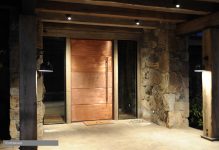 Contemporary copper clad pivot door.