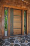 Wood meets metal. This contemporary door features walnut panels with steel bands.