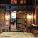Tanner Jackson - Custom plank style pivot entry door by AppWood at Lake Tahoe featuring steel straps, hand forged custom pull handle.