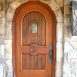 Whitson Entry 531 - A Mediterranean inspired design featuring a working speak easy, Rocky Mountain solid bronze door knocker and handset made in character mahogany with walnut panels, pecan stain and glaze by AppWood